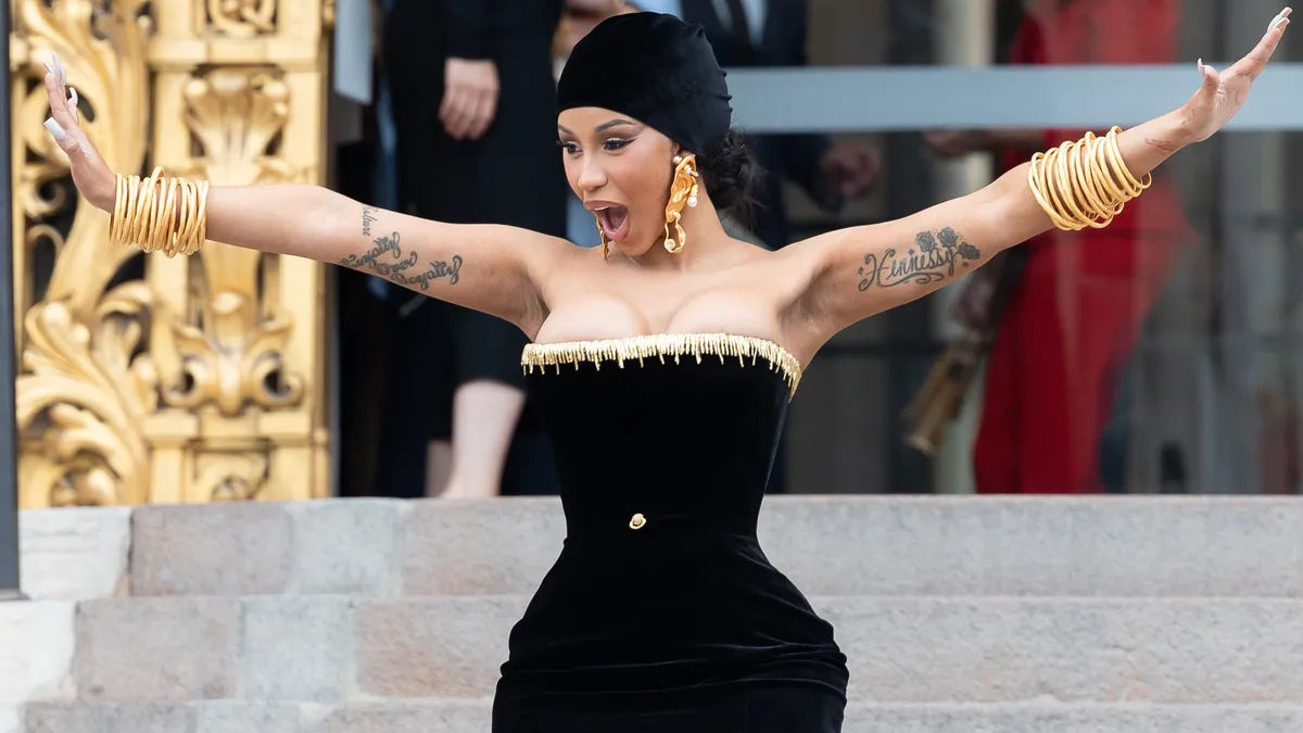 Featured image for Cardi B's Epic Mic Throw at Fan Who Doused Her Onstage