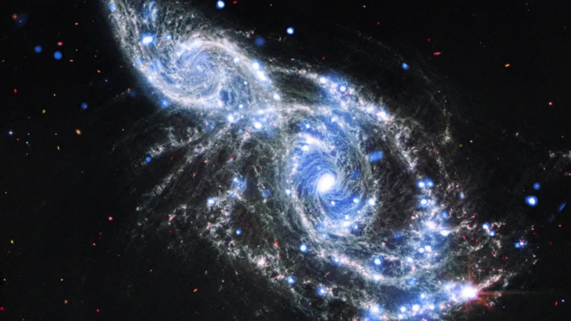 Featured image for Space Telescopes Capture Stunning Galactic Embrace