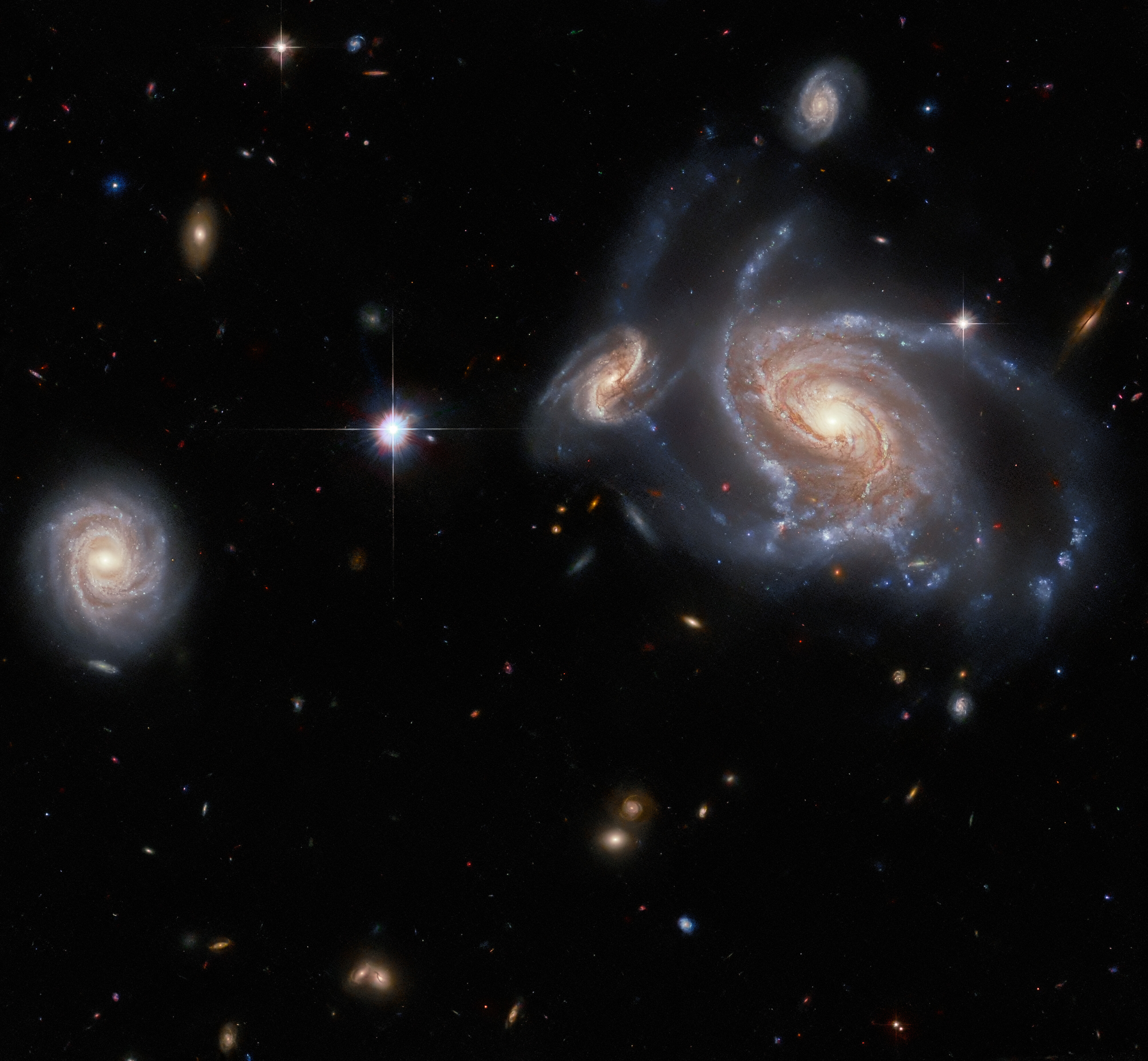 Featured image for "Hubble's Spectacular Snapshot: Overlapping Spiral Galaxies in a Vast Cosmic Neighborhood"